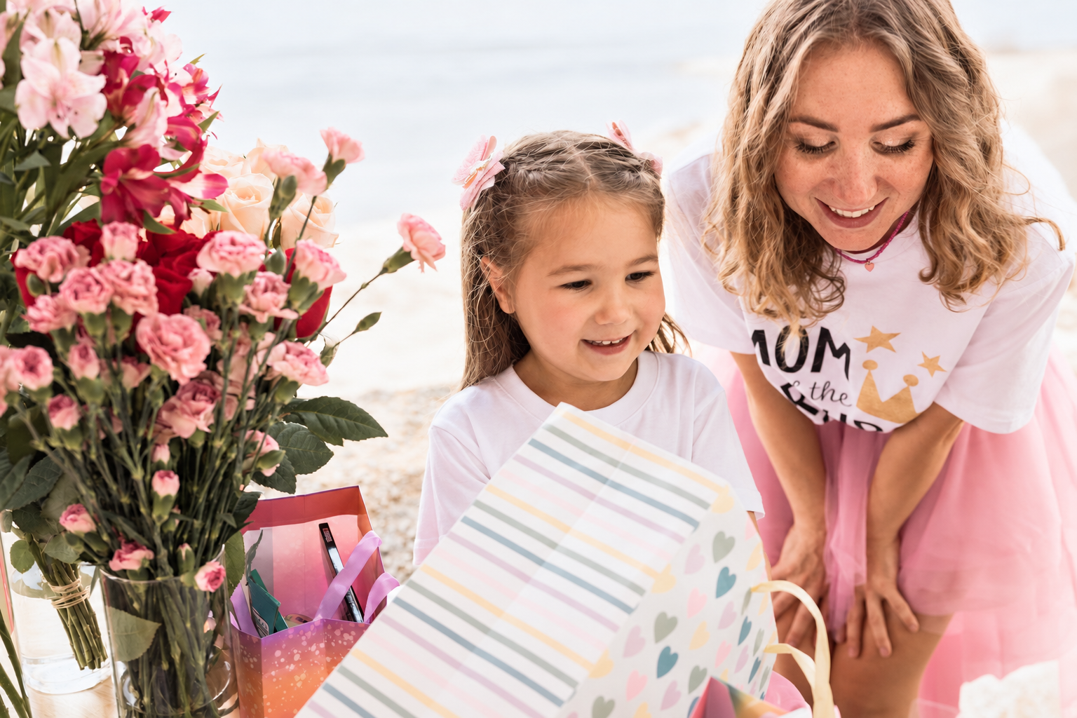 Marina and Olya smiling as they open birthday gifts together
